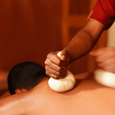 A herbal compress massage in progress