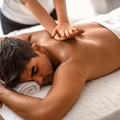 A guest mid-session, warm light on the treatment table