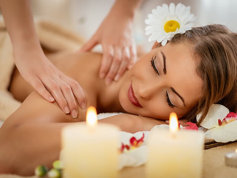 A guest's ritual moment, flowers and candlelight